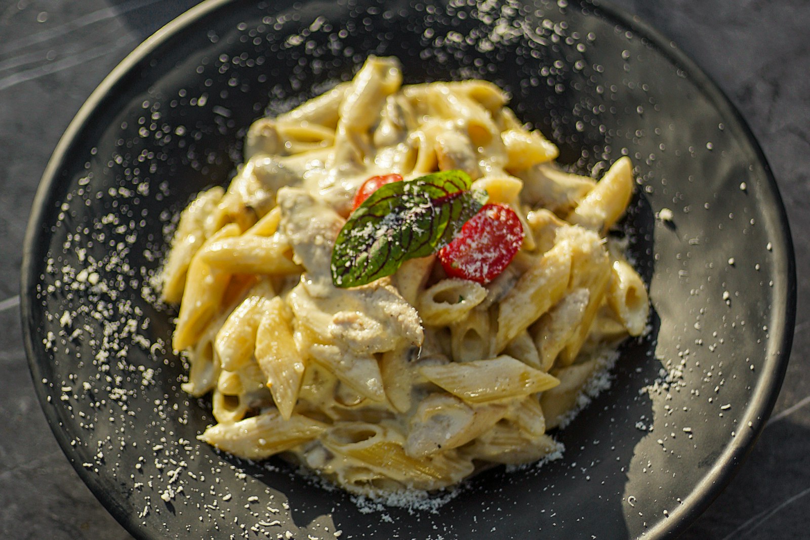 A plate of pasta at a restaurant table