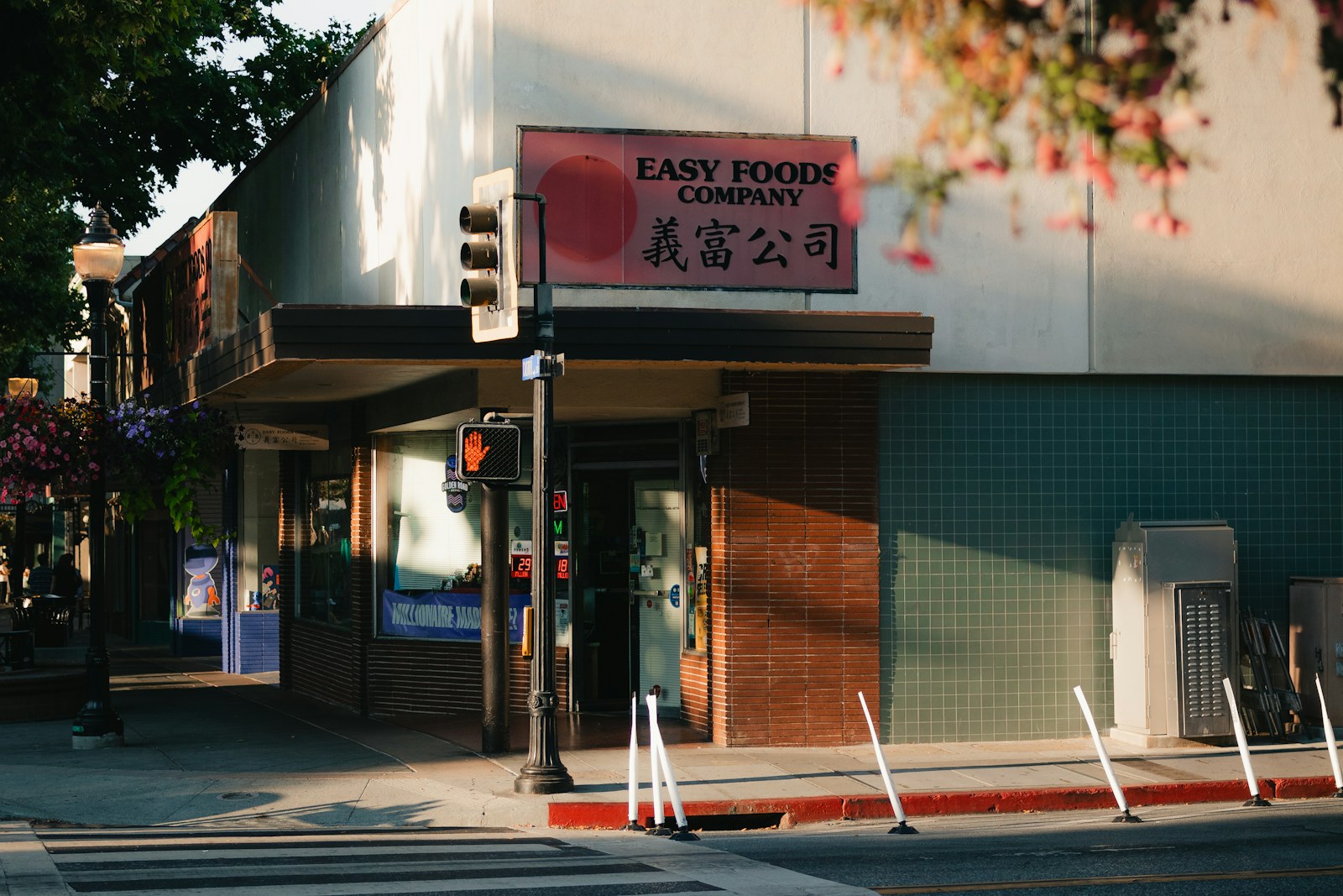 A street corner with a crosswalk and a corner store